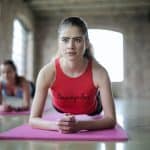 a woman doing a plank on a clean yoga matt