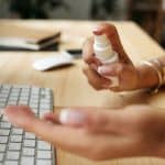 Using hand sanitiser in home office
